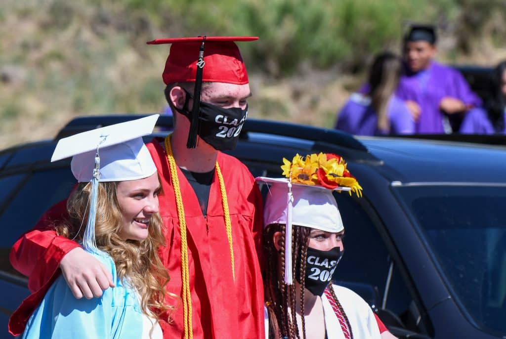 A trio of Yampah Mountain High School 2020 graduates stand for a photo before the start of the drive-in graduation ceremony Friday morning.