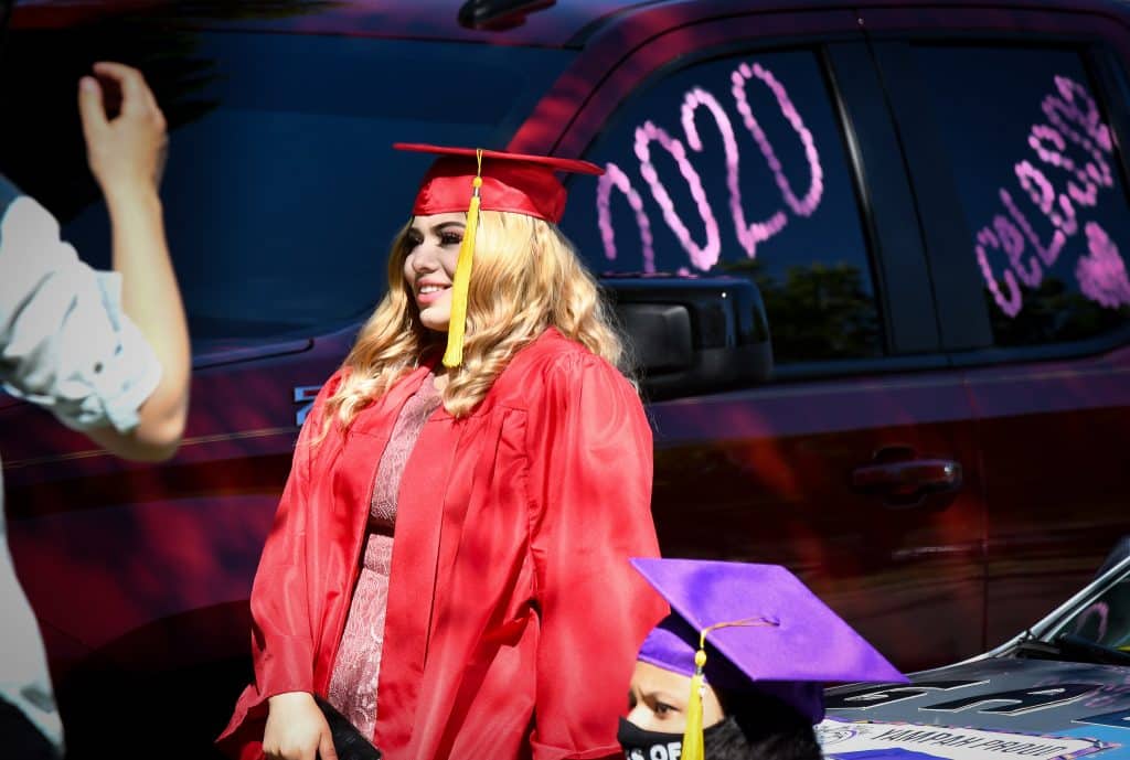 A 2020 Yampah Mountain High School graduate smiles for a photo before the start of the drive-in graduation ceremony on Friday morning.