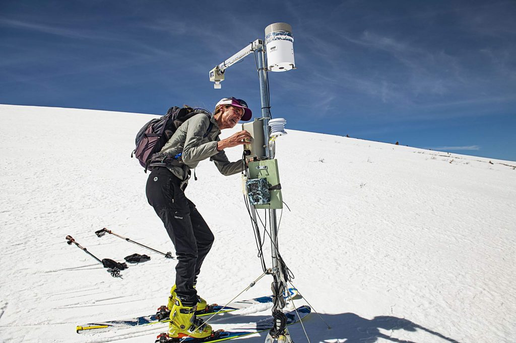 Independence Pass Foundation executive director Karin Teague resets the weather monitoring station near the summit of Independence Pass on Tuesday, May 5, 2020. (Kelsey Brunner/The Aspen Times)