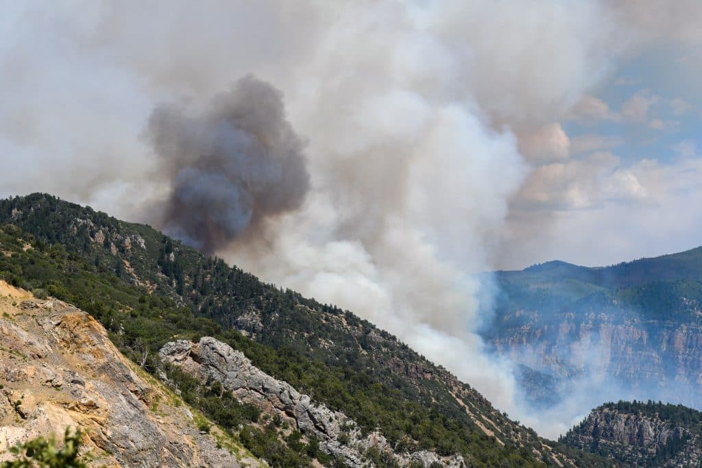 Smoke billows from the canyon walls as the Grizzly Creek Fire explodes in Glenwood Canyon on Monday afternoon.