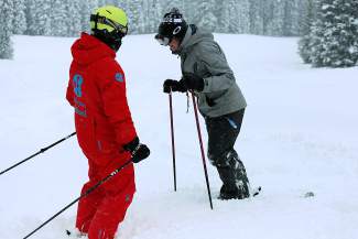 A ski instructor works with a student during a powder lesson at Copper Mountain. Local ski school instructors and ski club coaches recommend finding some type of professional instruction to move past plateaus, even if you're an intermediate or expert skier.