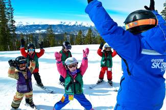 A ski instructor guides young students through a few flat-land exercises before heading onto the snow. Local resorts offer lessons for three types of students: beginners, intermediate/advanced skiers and expert skiers.