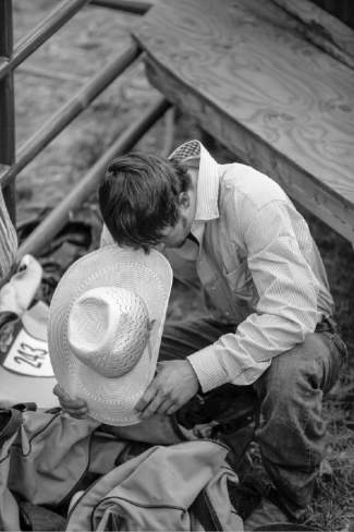 Dylan Wahlert, of Casper, Wyo., takes a moment before he competes in the bareback riding competition Wednesday at the Fair and Rodeo in Eagle.