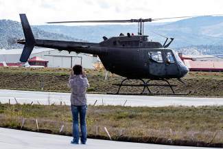 Joetta Gray takes a video while her husband Carl Gray takes his final lift-off before the helicopter and the pilot retire from the HAATS training center Wednesday in Gypsum.
