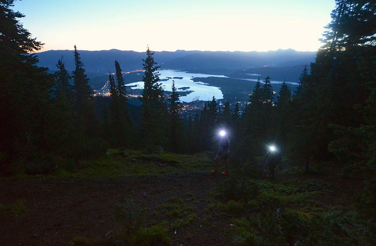 The sun begins to rise and reflect off Lake Dillon early on the approach to Peak One (12,805 feet) during the Tenmile Traverse.