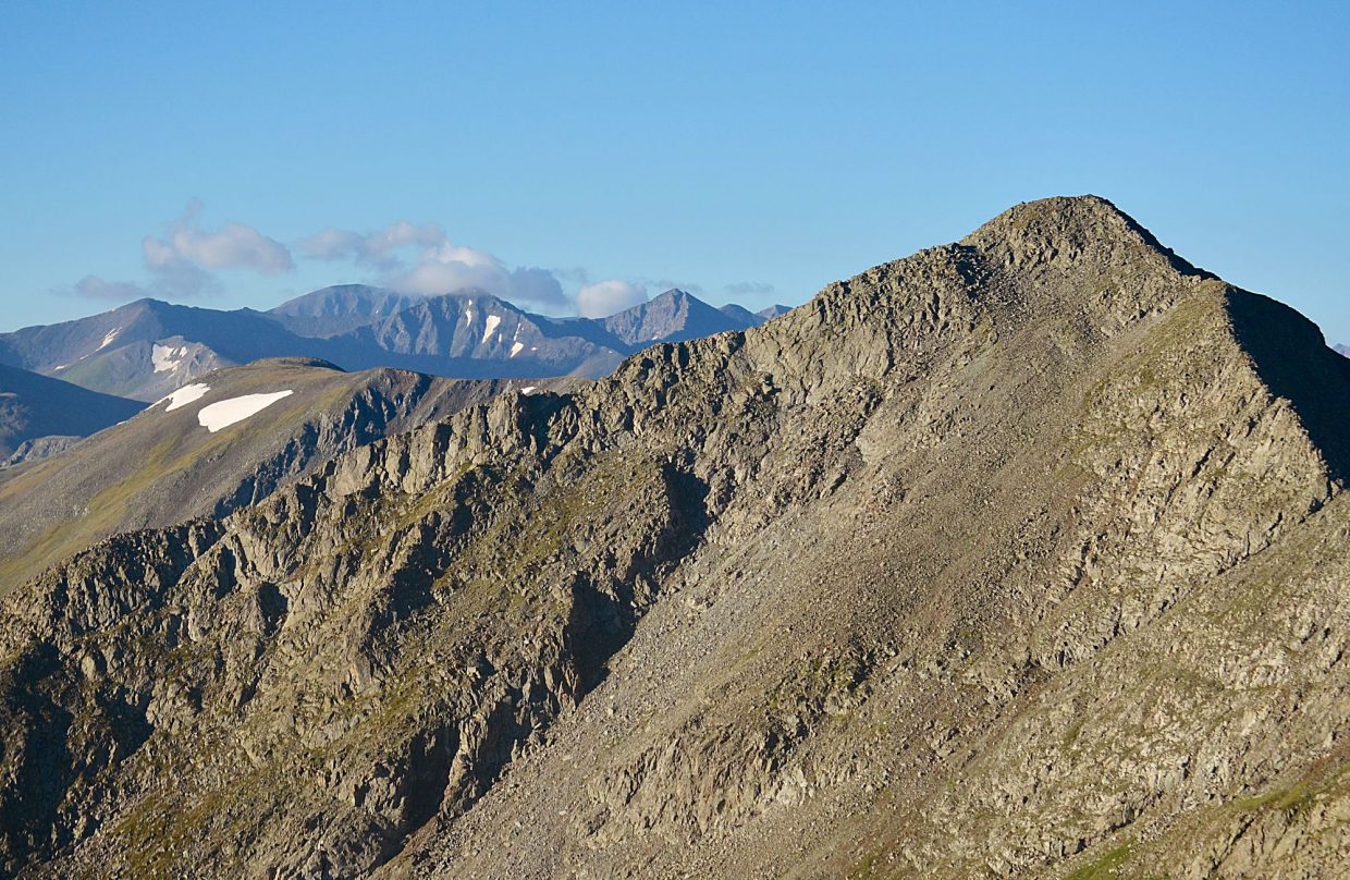 On a clear day, the Tenmile Traverse is relatively easy for routefinding thanks to a clear line of sight from one end to the other. Tenmile Peak (aka Peak Two 12,933 feet) is near on the right, with the flat north face of Quandary Peak (14,265 feet) far in the center background.