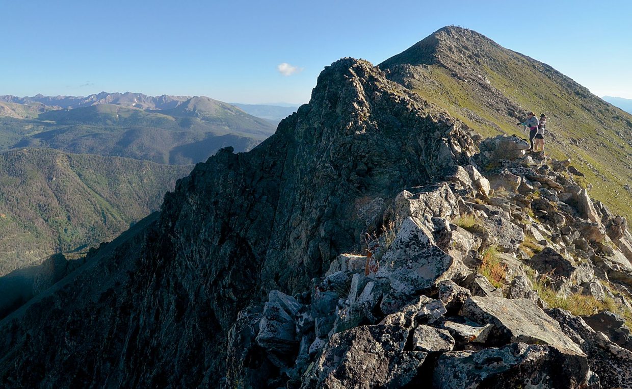 Hikers skirt around the false summit between Tenmile Peak (12,933 feet) and Peak Three (12,676) on an attempt of the Tenmile Traverse. The full traverse from Peak One to Peak 10 covers 14.5 miles and 8,500 feet of climbing, which takes anywhere from 6.5 hours to 15+ hours.