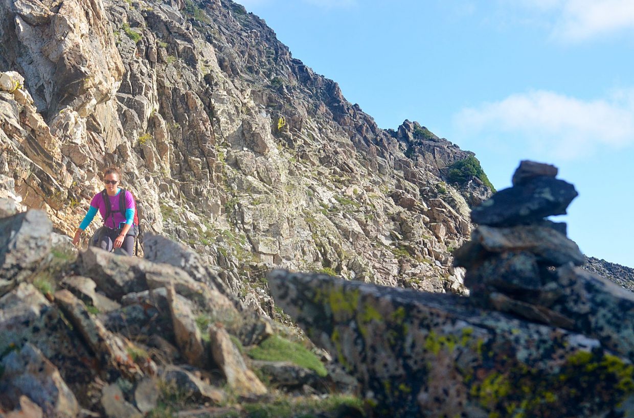 Frisco local Sara Skinner aims for a cairn marking the faint trail between Peak Three (12,676 feet) and Peak Four (12,866) during an attempt of the Tenmile Traverse in August.