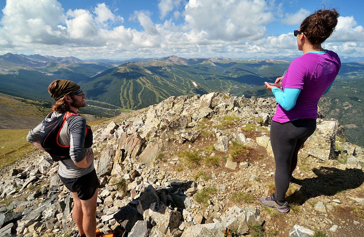 Local hikers Sara Skinner (purple) and Ben Trollinger stop for a snack and scenery at the summit of Peak Four (12,866) during an attempt of the Tenmile Traverse. The peak marks the end of precarious ridgeline scrambling and the start of long and unmarked ascents and descents through high-alpine tundra.