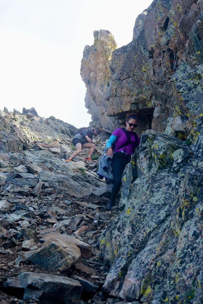 Local hikers Sara Skinner (purple) and Ben Trollinger weave through boulders and loose scree between Peak Three (12,676 feet) and Peak Four (12,866 feet) during an attempt of the Tenmile Traverse in August.