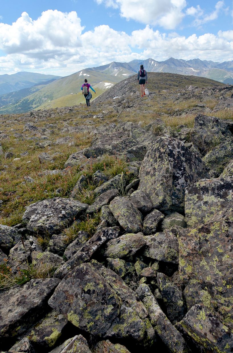 Local hikers Sara Skinner (purple) and Ben Trollinger make quick work of high-alpine routefinding between Peak Four (12,866 feet) and Peak Five (12,855 feet) during an attempt of the Tenmile Traverse.