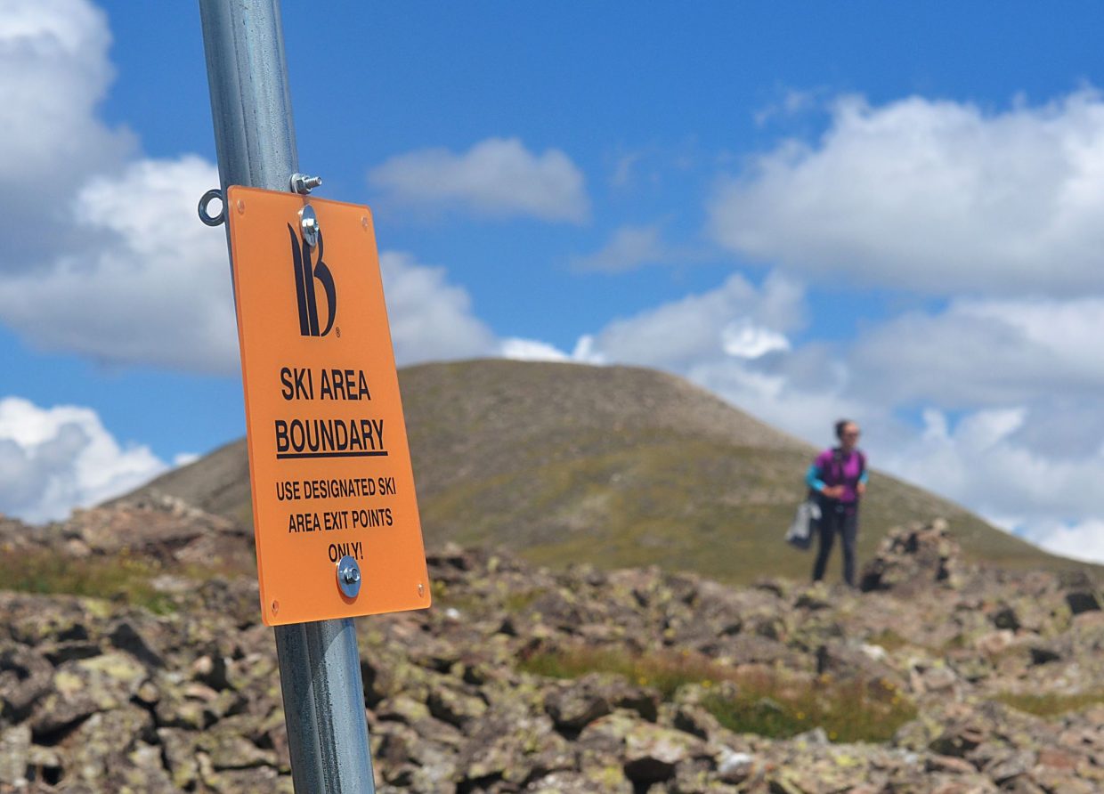 Frisco local Sara Skinner passes by a Breckenridge boundary sign marking the far north end of Peak Six (12,573 feet).