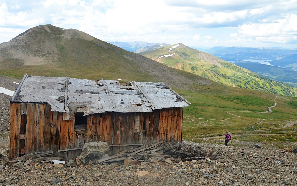 Frisco local Sara Skinner hikes past an abandoned shack on the side of the Peak 10 access road during an attempt of the Tenmile Traverse. There is no set route for the traverse, and so Skinner and our group added rouhgly 0.5 additional miles 400 vertical feet to take the road to the summit.