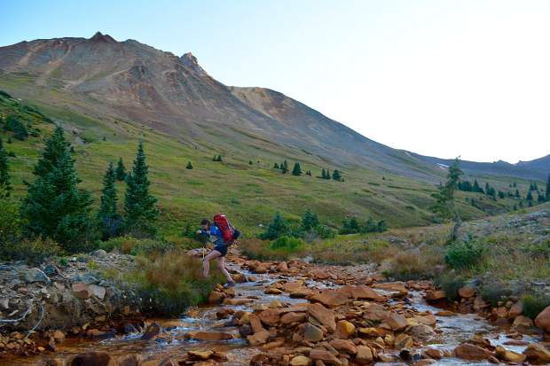 Forging a copper-colored stream on the approach to camp underneath the shadow of Uncompahgre Peak, Colorado's sixth highest 14,000 foot peak.