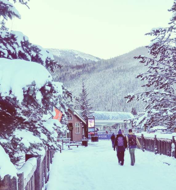 Skiers and snowboarders walk toward the River Run Gondola at the base of Keystone's Dercum Mountain early Saturday morning.