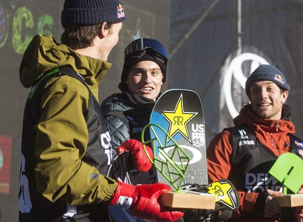 Eagle product Jake Pates, at top of podium, of United States interacts with Scotty James, far left, following the superpipe finals during the Dew Tour event Friday, Dec. 15, at Breckenridge Ski Resort. Pates took home first with a high score of 97.