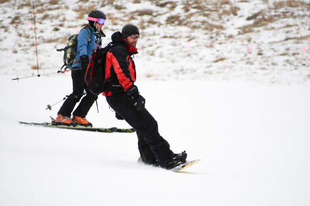 Snowboarders and skiers make their way down the slope at Sunlight Mountain Resort.