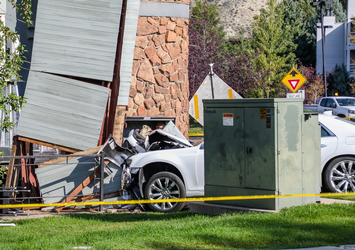A car is seen crashed into a support beam on the 