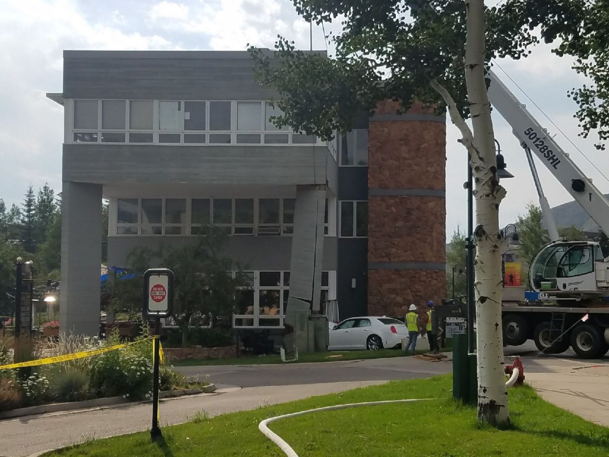 Construction crews can be seen supporting the column of the Benchmark Plaza building getting ready to begin work.
