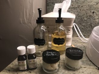 Several bottles of oil sit on a counter.