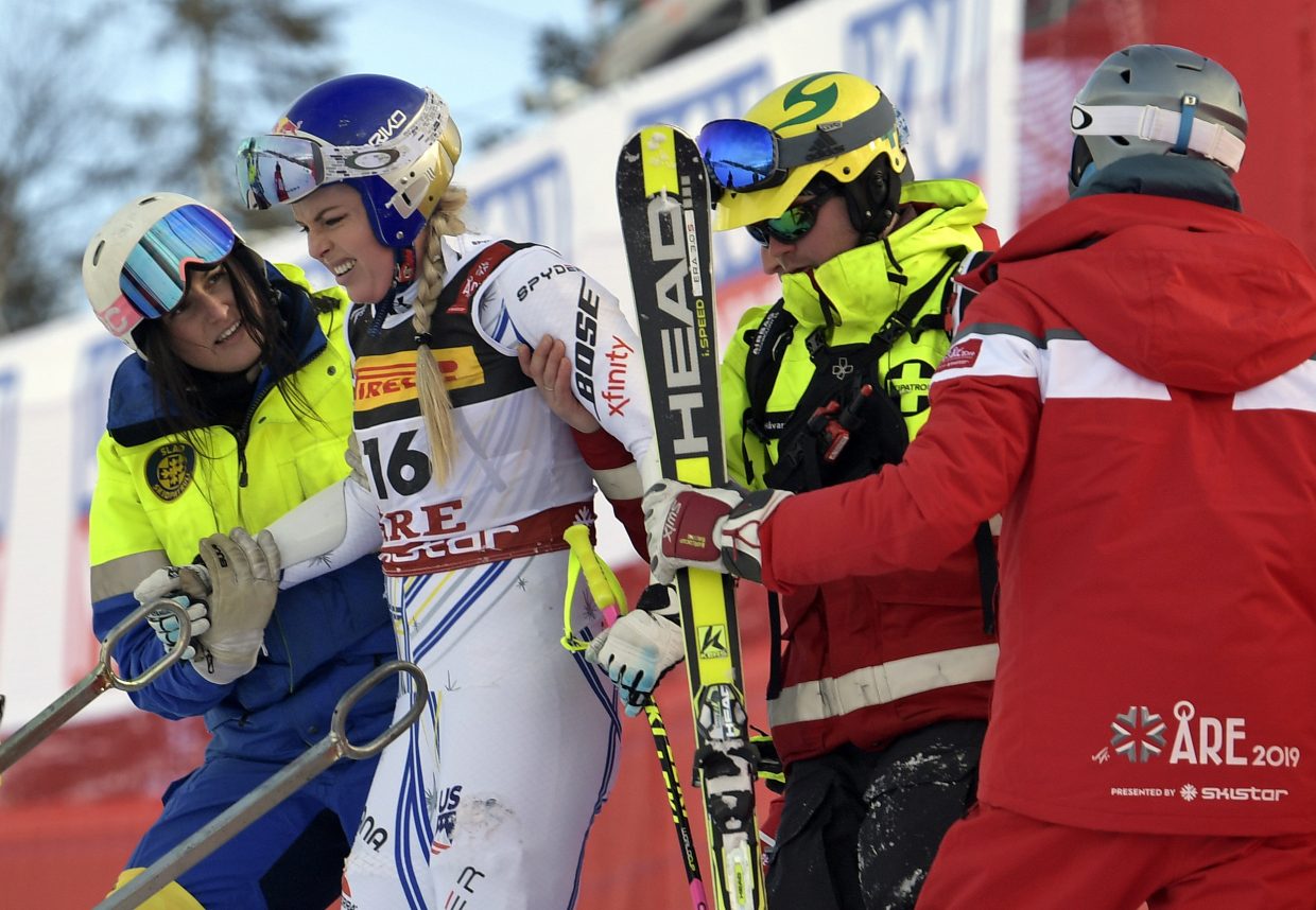 Lindsey Vonn is assisted after crashing during the women's super-G at the FIS Alpine World Ski Championships. Vonn was able to ski down the hill under her own power.