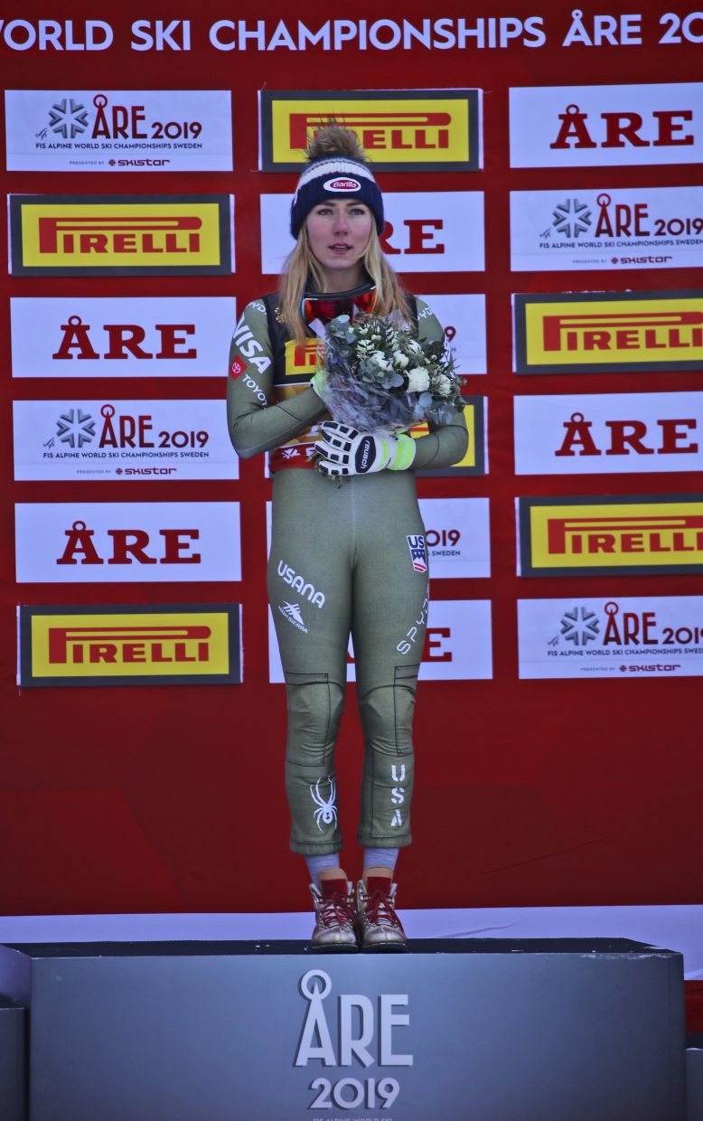 Mikaela Shiffrin listens to the national anthem after winning super-G gold at the FIS Alpine World Ski Championships in Are Sweden, on Tuesday. Shiffrin will not ski during Sunday's downhill and has yeat to make a decision on whether she will compete in Friday's super-combined.