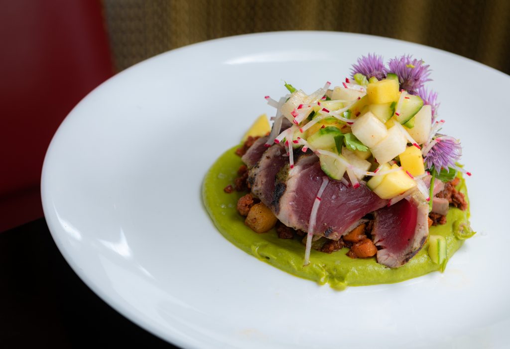 Coriander Tuna | seared rare, sweet potato, house chorizo, chayote squash, mango slaw, avocado  from Maya in Avon.