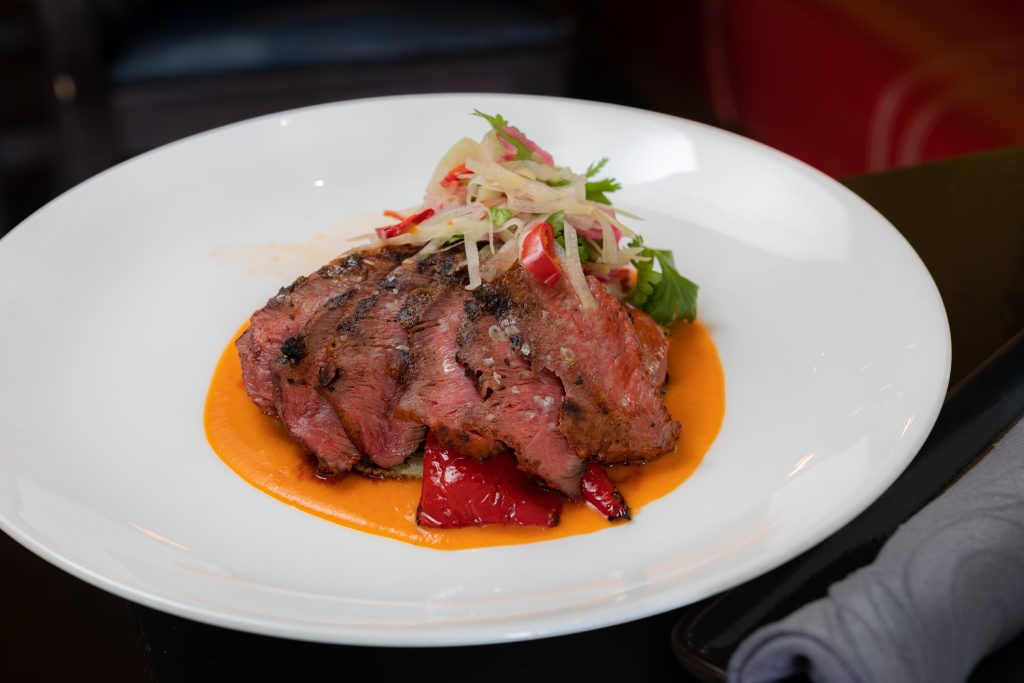 Carne Asada | flat iron steak, fire grilled vegetables, achiote, hoja santa tortilla, chile pulla, black bean purée  from Maya in Avon.