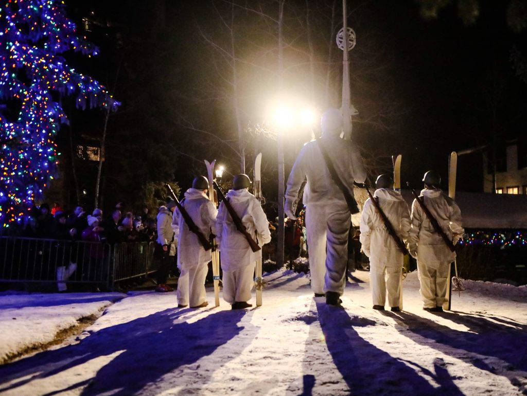 Military veterans pose in front of the 10th Mountain Division statue and memorial during the 10th Mountain Legacy Parade in Vail. The ski down and parade will run through Vail Village and guests can learn more about the division's contributions to military and ski history at the Colorado Snowsports Museum, which will be open after-hours.