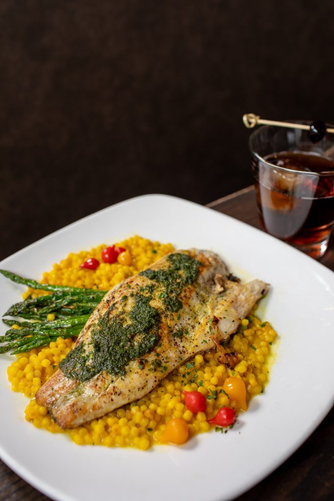 Pesto-roasted barramundi with saffron couscous and asparagus.