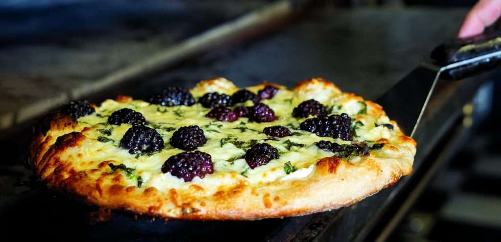 Briana's Blackberry Pizza, featuring a white pizza with ricotta, basil, fresh blackberries and honey.