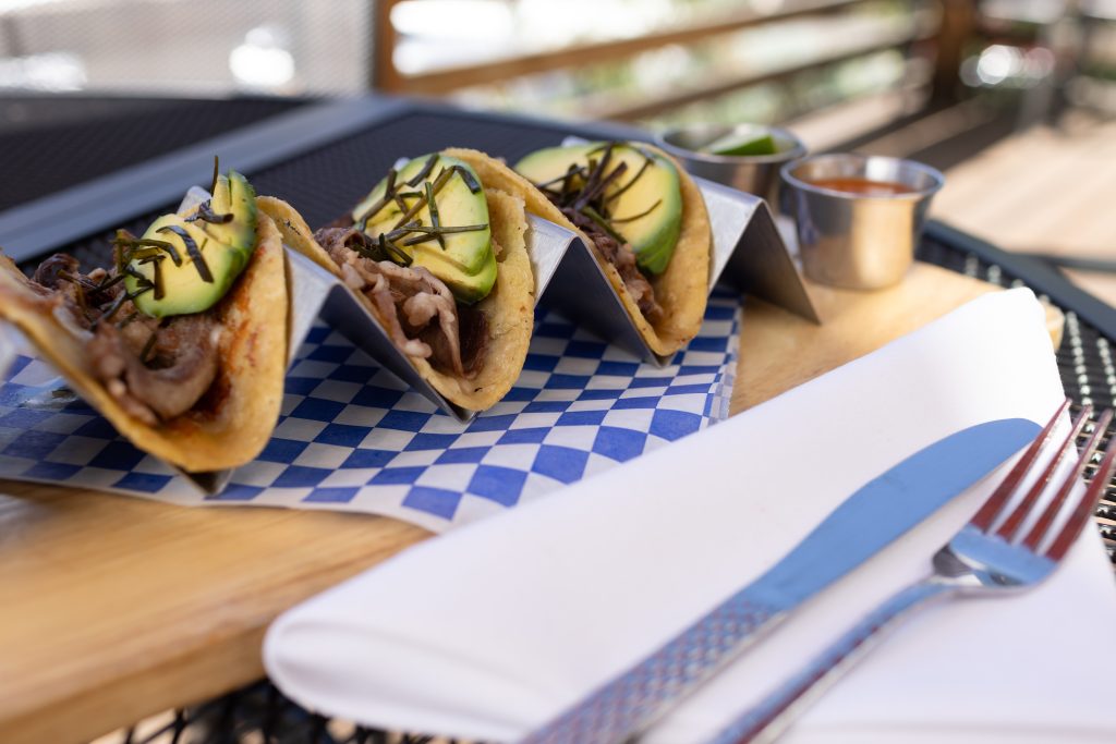 Ribeye tacos with a cheese crust, avocado and fried chives.