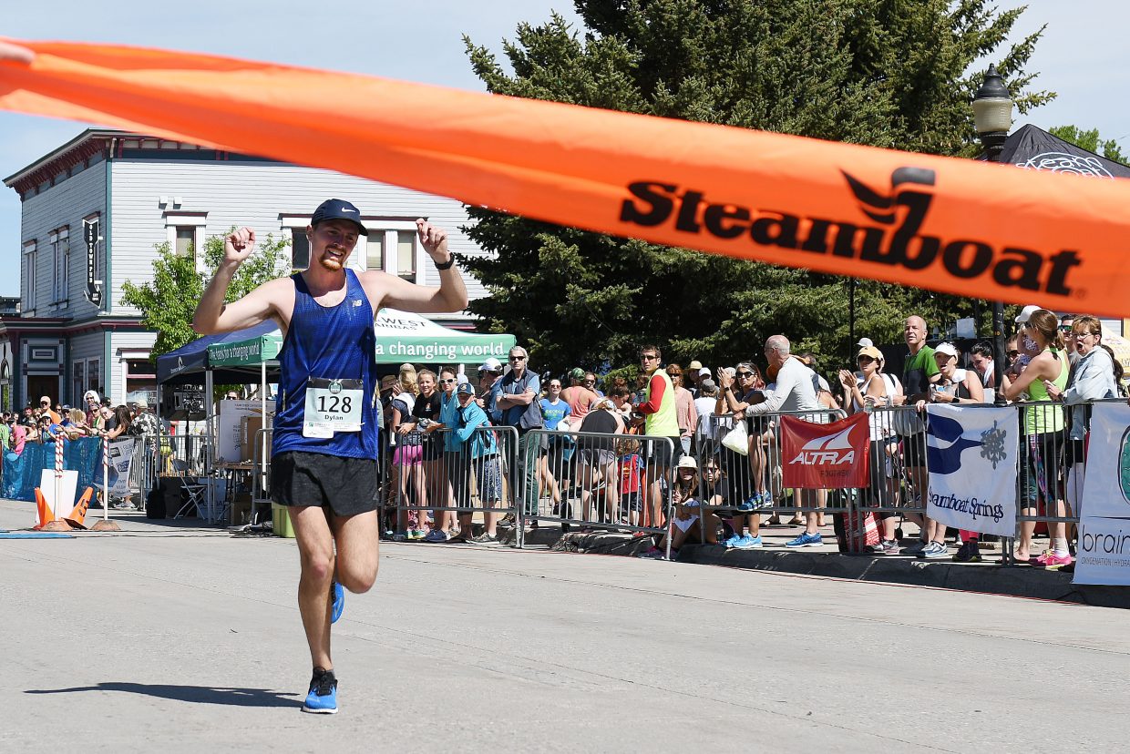 Dylan Jennings pumps his fists as he approaches the finish of the Steamboat Marathon.