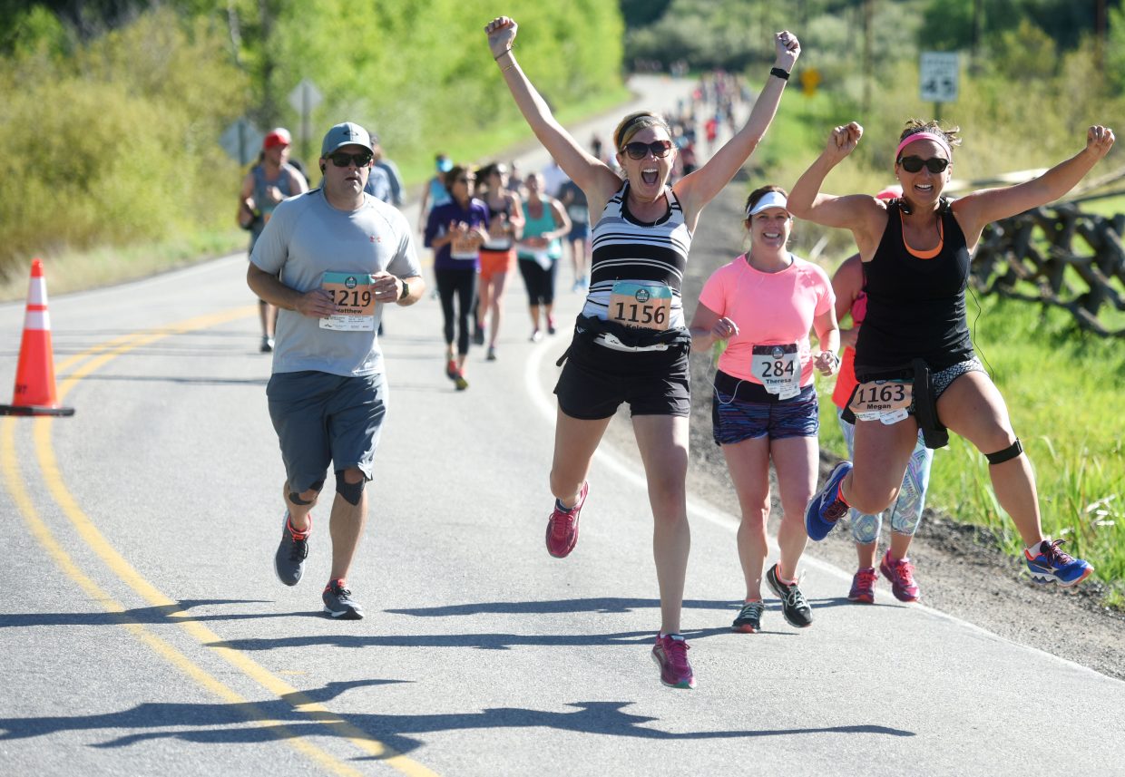 Some runners, in this case, Kelsey Cochrane, left and Megan Conklin, had energy left over midway through the Steamboat Marathon half-marathon race.