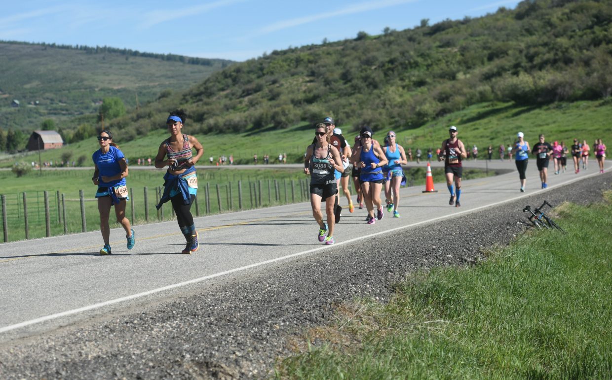 Half-marathon runners head toward Steamboat Springs on Sunday during the Steamboat Marathon