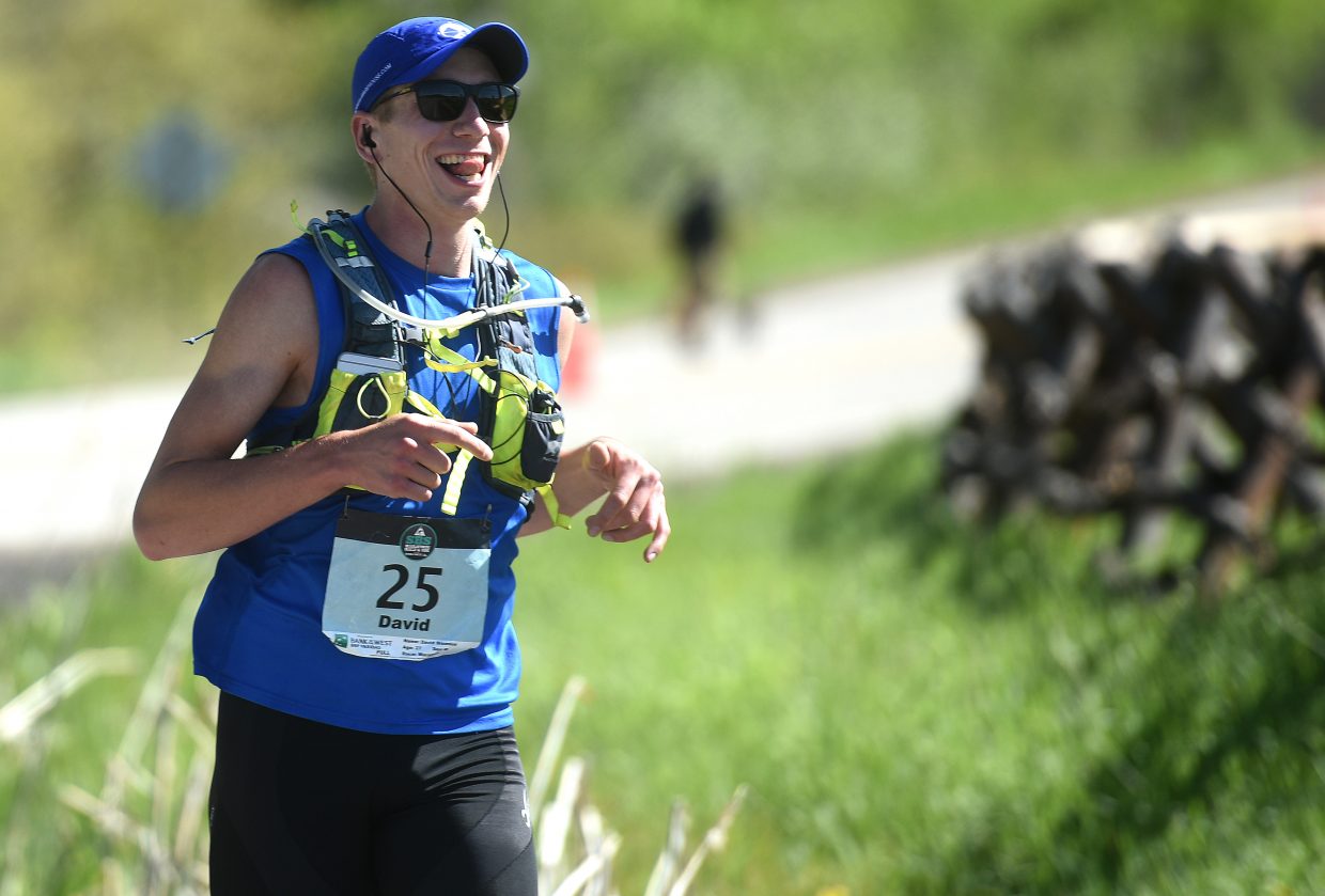 David Bisenius smiles wide as he runs Sunday during the Steamboat Marathon. He went on to finish third. 