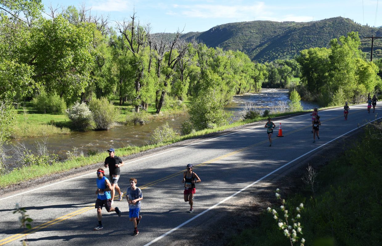 Runners make their way toward Steamboat Springs on Sunday during the Steamboat Marathon.