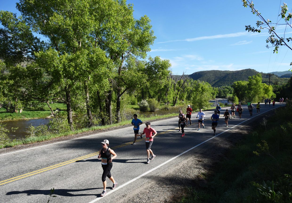 Runners cruise down County Road 129 on Sunday during the Steamboat Marathon.