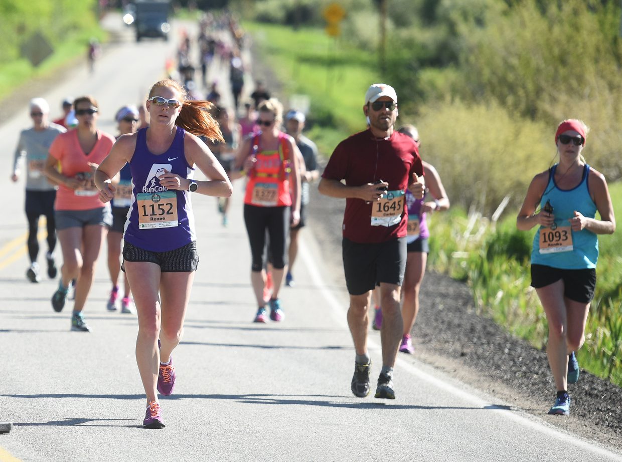 Runners chug up a hill on Sunday during the Steamboat Marathon.