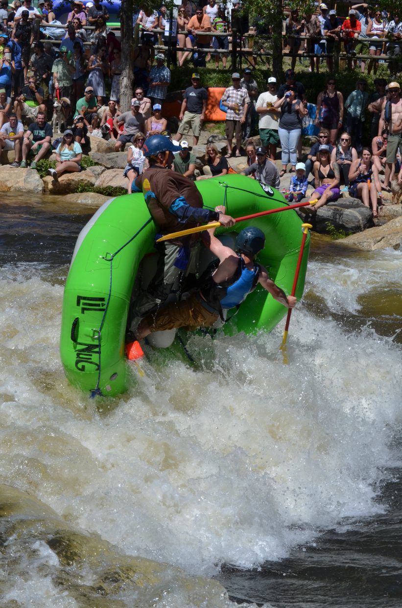 A pair of rafters can't overcome the standing wave in Charlie's Hole during the 2017 Yampa River Fest.