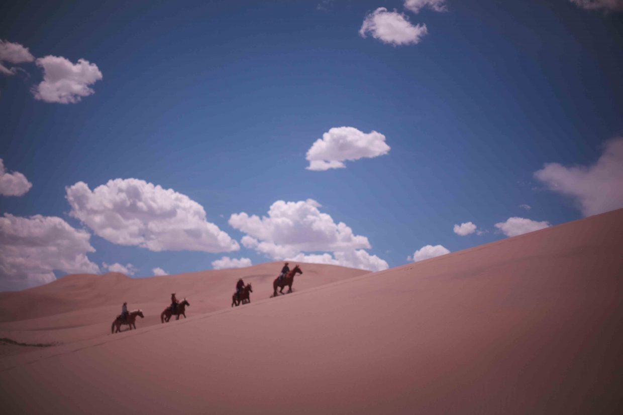 At the Zapata Ranch, visitors ride horses near the sand dunes in the Great Sand Dunes National Park and Preserve. Ranchlands, the ranch management company that manages the Zapata Ranch, invites artists to live on the ranch for a week, and the work they create from that experience will be on display at the Depot Art Center for the month of March.