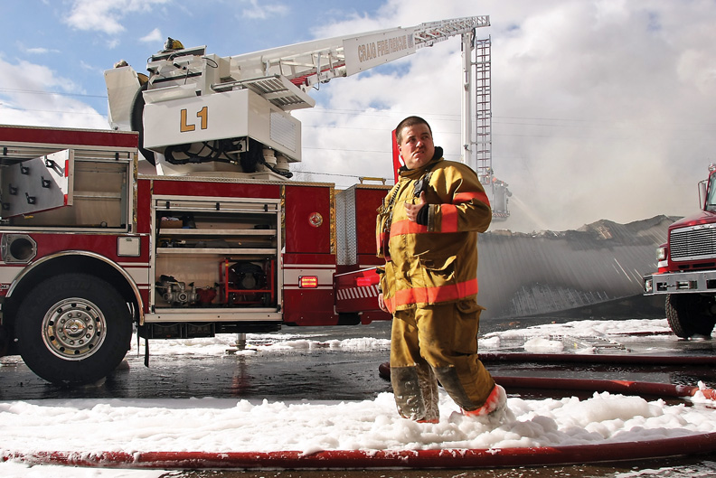 Craig Fire/Rescue worker Kris Olsen walks through a mixture of foam fire retardant and water during the Wednesday fire at the Craig Motel.
