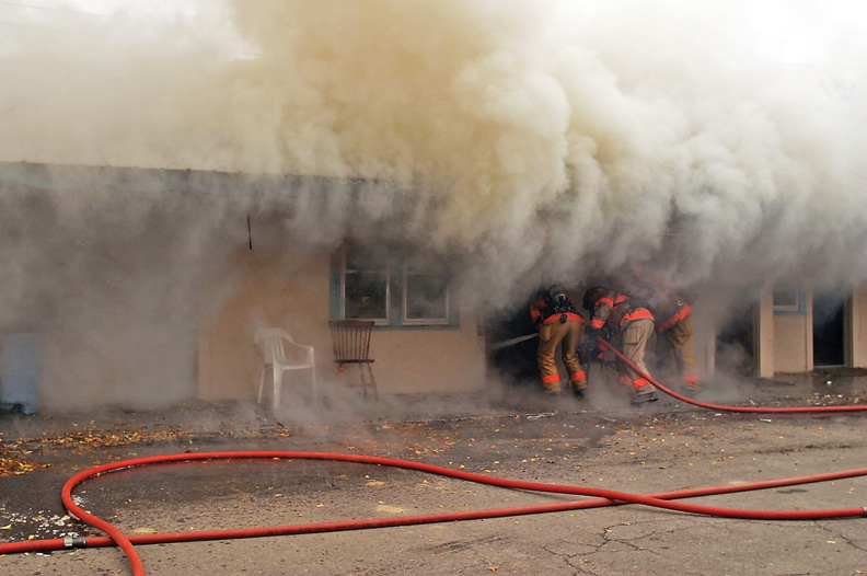 Craig Fire/Rescue workers make their way into Room 11, the origin of Wednesday's fire at the Craig Motel. 
