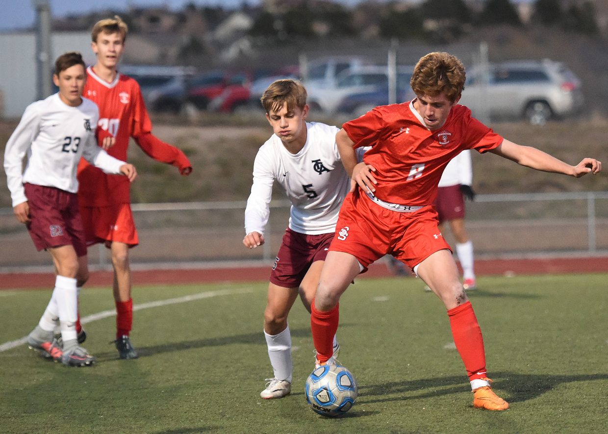 Steamboat’s Cruz Erickson battles for the ball Tuesday against The Classical Academy.