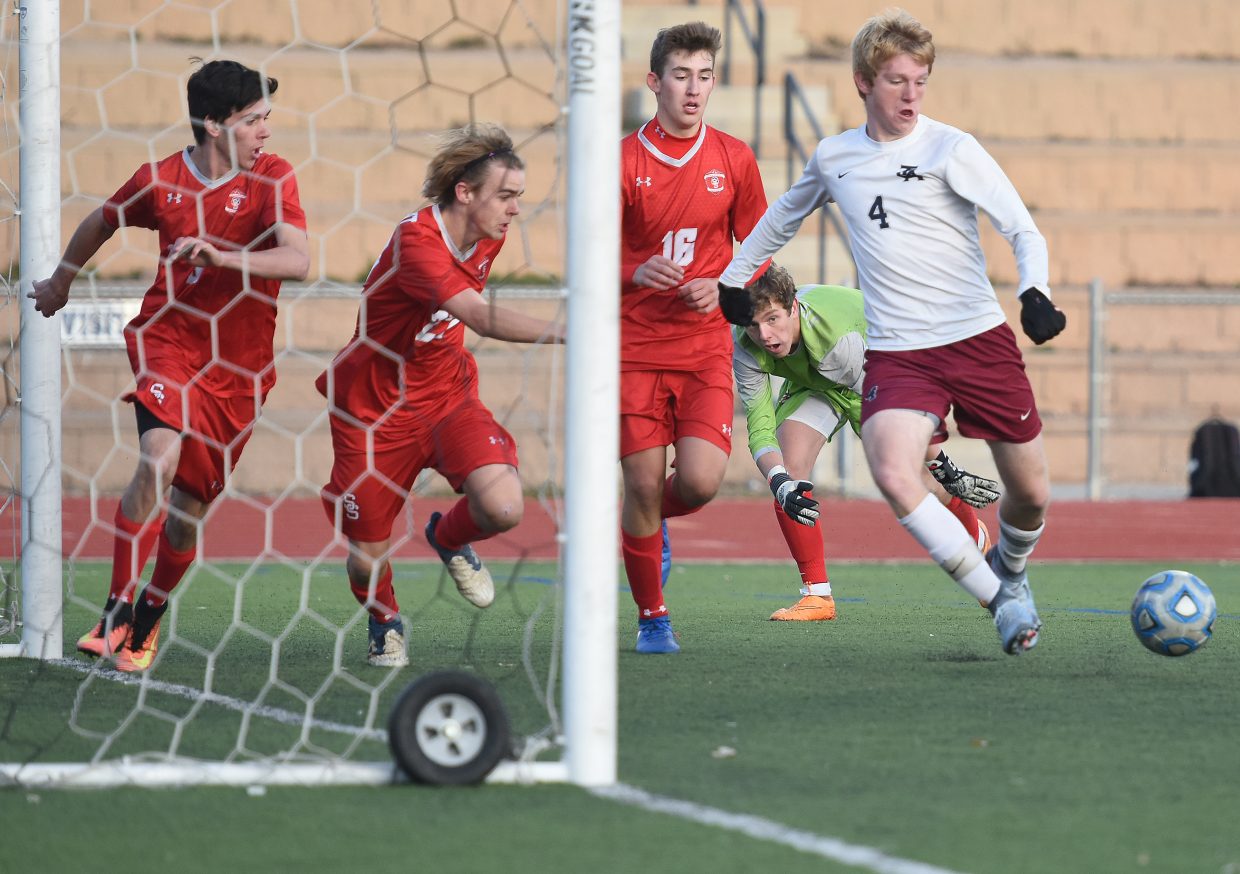 The Steamboat defense scrambles to get in front of The Classical Academy senior Jake Slater during Tuesday’s second-round Class 4A state playoff game in Colorado Springs. Slater weaved his way through that defense to score on the play, one of two goals he had in what was a 4-0 victory for his squad.