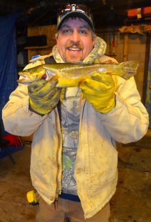 Eric Lawing displays the fish he submitted for measurement early Friday morning.