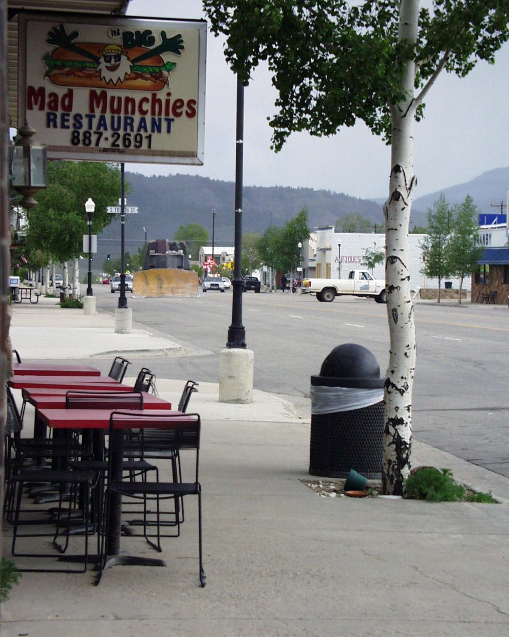 An armed bulldozer drives down Granby's main street towards Sky-Hi News on June 4, 2004. The destruction that day caused a forced revitalization of the town, but it came with an emotional cost.