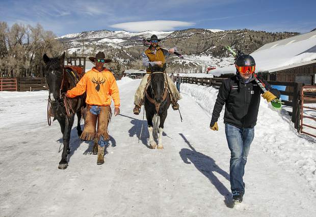 Summit County skijoring competitors, Al Mikkelsen (left) AJ Pestello (horseback) and Vinny Pestello walk down the driveway at Pass Creek Ranch, where Mikkelsen is the caretaker, near Ute Pass north of Silverthorne, on Wednesday Feb. 27.