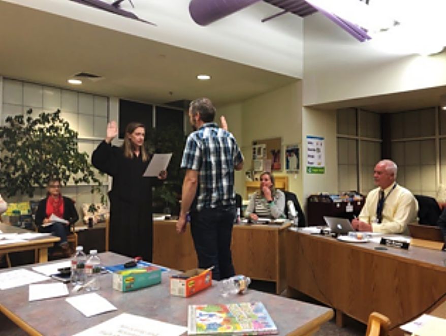 Shaul Hagen is sworn in as a new member of the East Grand School Board by Judge Mary Hoak at a board meeting in Fraser on Feb. 18.
