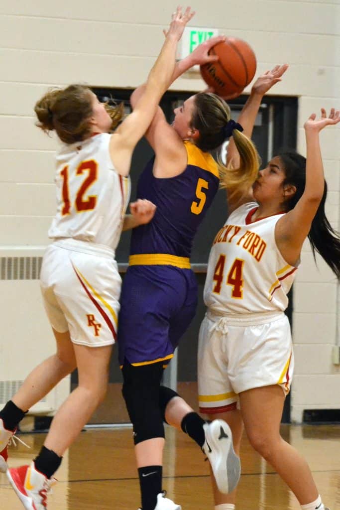 West Grand’s Alex Schake (5) fights to put up a shot amidst aggressive defending by Rocky Ford’s Lily Hancock (12) and Nevaeh Rodriguez (44) during Class 2A Region 8 Tournament semifinals action this past Friday, March 6, at event-hosting Ignacio High School.  Seeded 24th in the State Championships’ initial Round-of-32, the Lady Mustangs (13-11 overall) suffered a season-ending, 54-25 loss to the 9-seed Meloneers. Schake battled for six points in defeat, and was a rebounding presence RFHS struggled to out-perform.